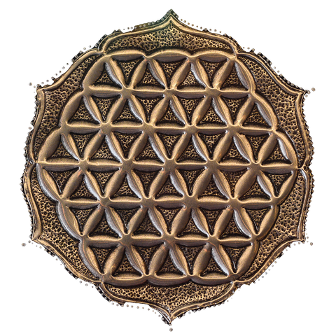 A metal relief with a flower of life motif on a dark background